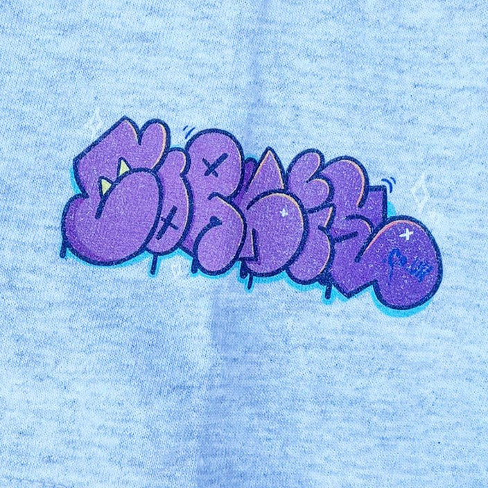 Graffiti bubble letter logo for indie brand CORKiE, in a graffiti throwie font printed onto the sleeve of a streetwear t-shirt.