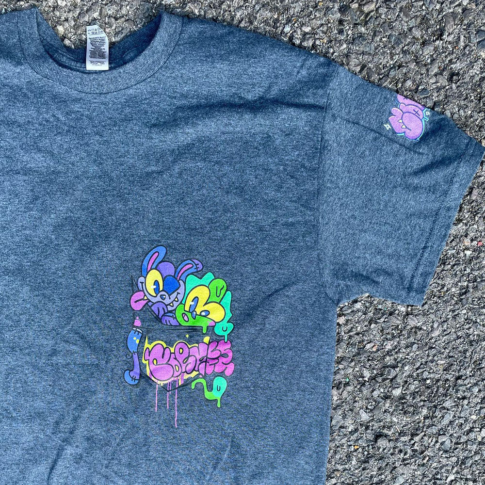 Indie streetwear brand CORKiE grey t-shirt. Featuring a graphic design with two retro graffiti style characters in the shirts pocket. With a throwie bubble text logo on the sleeve.