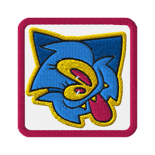 embroidered patch of a blue furry monster character by Brighton street artist CORKiE