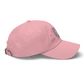 a pink indie street wear cap with a furry character embroidered on the front