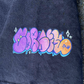 Graffiti bubble letter logo for indie brand CORKiE, in a graffiti throwie font printed onto the sleeve of a streetwear t-shirt.