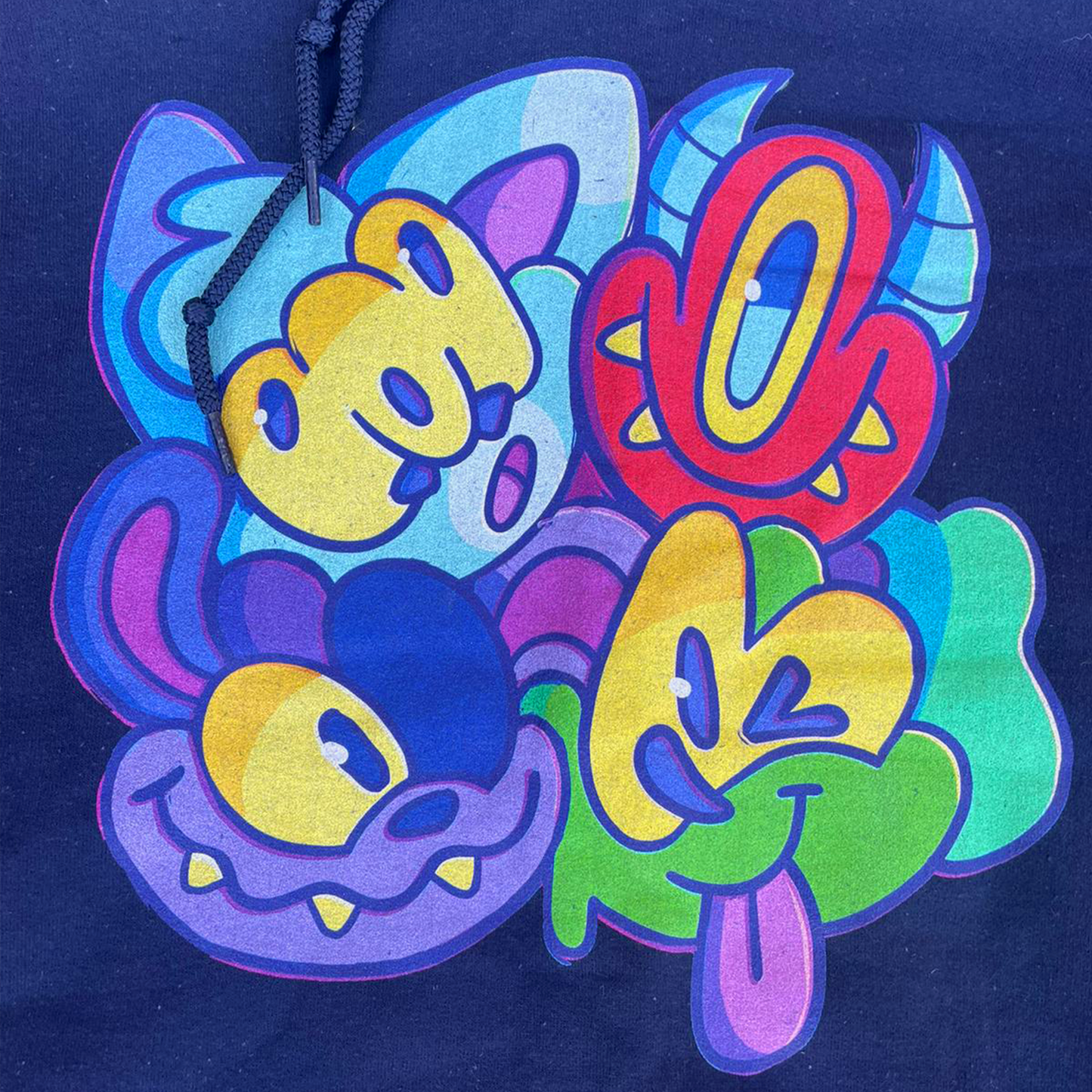 Close up of graffiti characters on CORKiE hoodie.