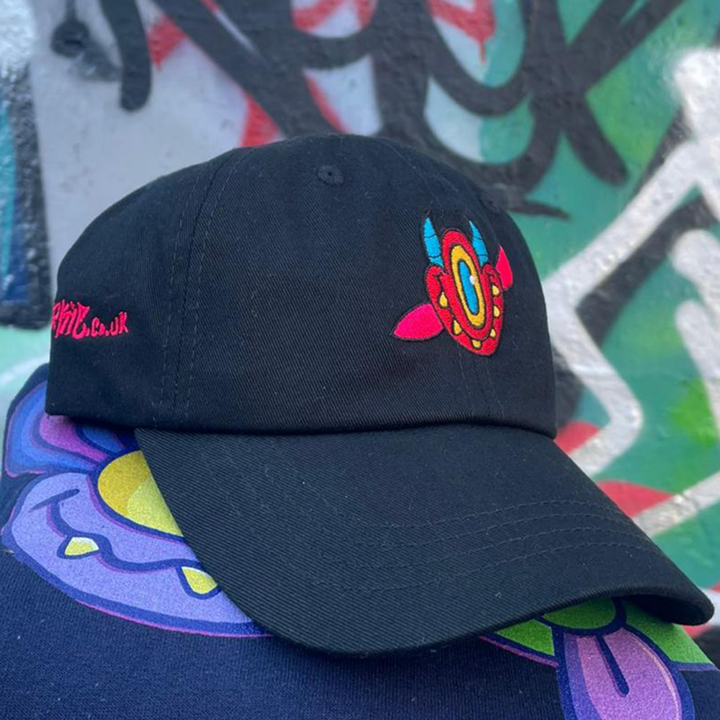 Close up of DiABLO graffiti style hat, with ah character on the front and tag on the side.